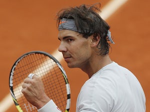 Rafael Nadal celebrates after defeating Martin Klizan during their second round match of the French Open on May 31, 2013