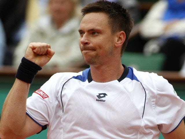 Robin Soderling celebrates winning a point against Roger Federer at the French Open