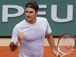 Roger Federer celebrates after defeating Julien Benneteau during their third round match of the French Open on May 31, 2013