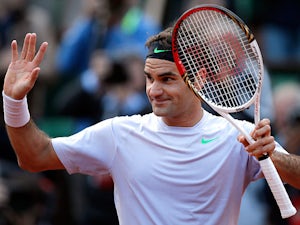 Roger Federer celebrates after defeating Gille Simon during their fourth round match of the French Open on June 2, 2013