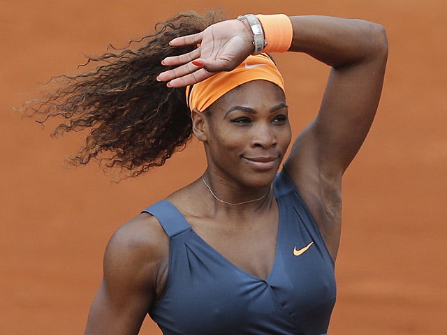 Serena Williams waves to fans after defeating Sorana Cirstea during their third round match of the French Open on May 31, 2013