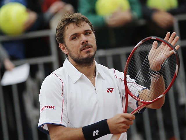 Stanislas Wawrinka celebrates after defeating Horacio Zeballos during their second round match of the French Open on May 31, 2013