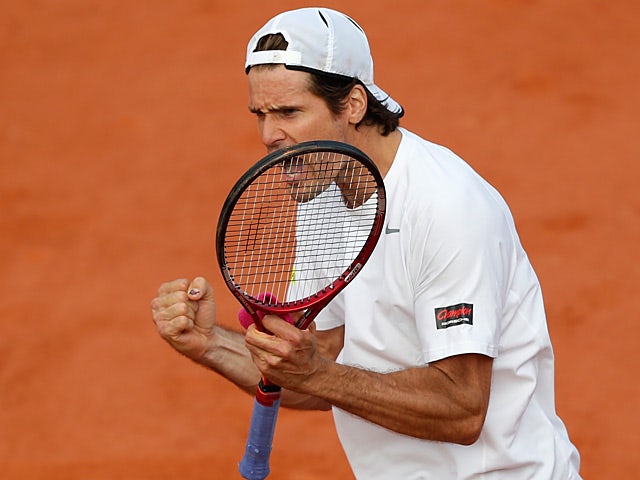 Tommy Haas celebrates after defeating John Isner during their third round match of the French Open on June 1, 2013