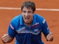 Tommy Robredo celebrates after defeating Gael Monfils during their third round match of the French Open on May 31, 2013
