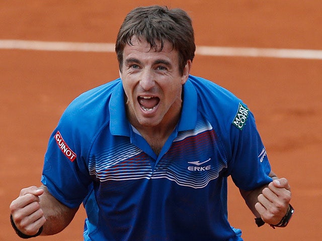 Tommy Robredo celebrates after defeating Gael Monfils during their third round match of the French Open on May 31, 2013