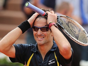 Tommy Robredo celebrates after defeating Nicolas Almagro during their fourth round match of the French Open on June 2, 2013