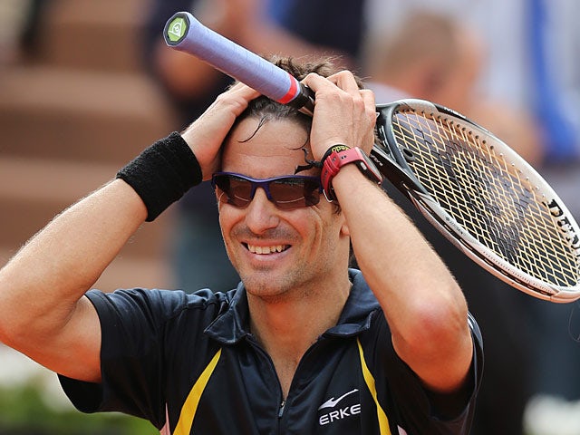 Tommy Robredo celebrates after defeating Nicolas Almagro during their fourth round match of the French Open on June 2, 2013