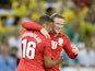 England's Wayne Rooney is congratulated by team mate Alex Oxlade-Chamberlain after scoring his team's second goal against Brazil during a friendly match on June 2, 2013