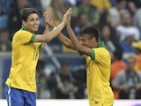 Brazil's Oscar celebrates his goal with teammate Neymar during their friendly soccer game against France on June 9, 2013