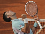 Serbia's Novak Djokovic celebrates defeating Germany's Tommy Haas in three sets during their Quarter Final match at the French Open tennis tournament on June 5, 2013