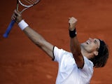 Spain's David Ferrer reacts as he defeats France's Jo-Wilfried Tsonga during their semifinal match of the French Open tennis tournament on June 7, 2013