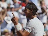 Spain's Rafael Nadal gestures as he defeats Serbia's Novak Djokovic during their semifinal match of the French Open tennis tournament on June 7, 2013