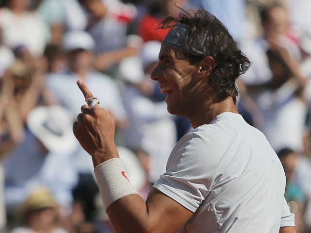 Spain's Rafael Nadal gestures as he defeats Serbia's Novak Djokovic during their semifinal match of the French Open tennis tournament on June 7, 2013