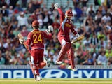 West Indies' Kemar Roach and Denesh Ramdin celebrate their victory during the ICC Champions Trophy match against Pakistan on June 7, 2013