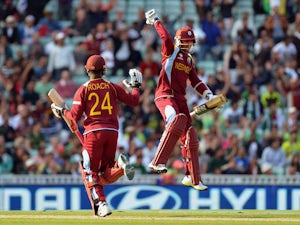 West Indies' Kemar Roach and Denesh Ramdin celebrate their victory during the ICC Champions Trophy match against Pakistan on June 7, 2013
