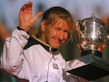 Steffi Graf celebrates with the French Open trophy.