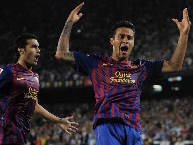 Thiago celebrates his goal for Barcelona with Pedro.