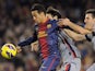 Barcelona attacker Thiago holds off two challenges.