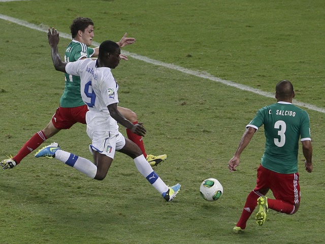 Italy's Mario Balotelli kicks the ball to score his team's second goal during the soccer Confederations Cup group A match between Mexico and Italy on June 16, 2013