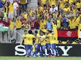Brazil players congratulate Neymar following a goal against Japan on June 15, 2013
