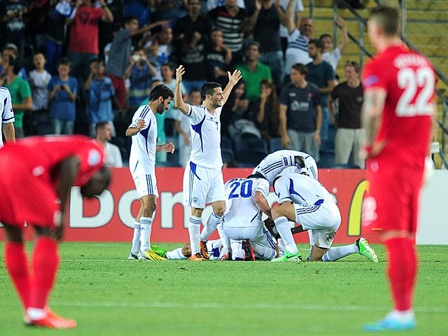 Israel's Ofir Kriaf is mobbed by team mates after scoring the opener against England during the European U21 Championships on June 11, 2013