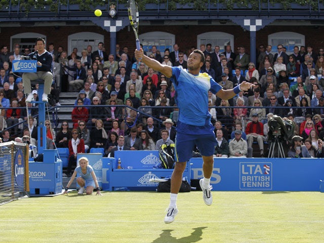 Jo-Wilfried Tsonga of France plays a return to Igor Sijsling of the Netherlands during theirthird round match at the Queen's Club on June 13, 2013
