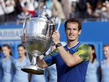 Andy Murray celebrates with the trophy after beating Marin Cilic in the final of the AEGON Championships at The Queen's Club on June 16, 2013