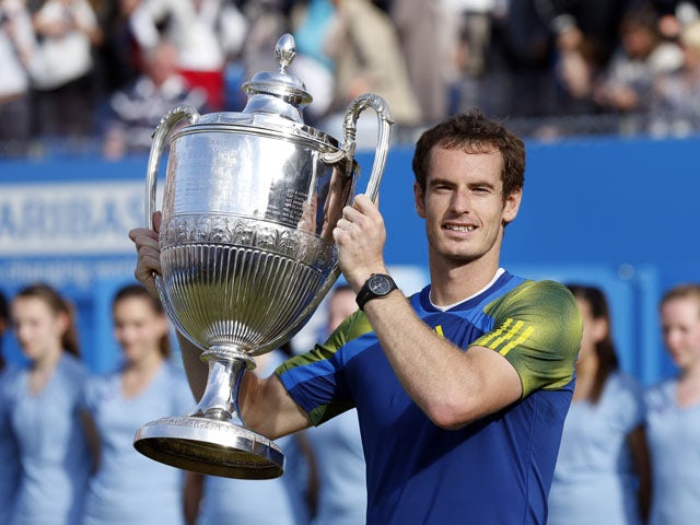Andy Murray celebrates with the trophy after beating Marin Cilic in the final of the AEGON Championships at The Queen's Club on June 16, 2013
