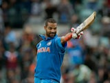 India's Shikhar Dhawan celebrates his century during the ICC Champions Trophy against the West Indies on June 11, 2013