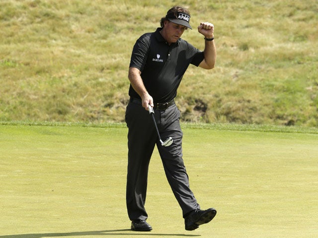 Phil Mickelson reacts after his birdie putt on the ninth hole during the first round of the U.S. Open golf tournament on June 13, 2013