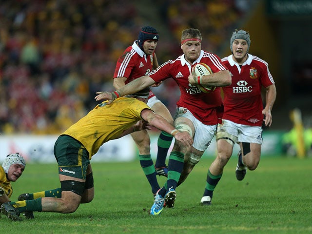 British and Irish Lions' Jamie Heaslip holds off a tackle from Australia's Kane Douglas on June 22, 2013