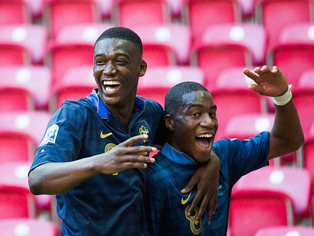 France's Geoffrey Kondogbia is congratulated by team mate Yaya Sanogo against Ghana during the Under-20 World Cup on June 21, 2013