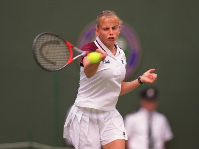 Jelena Dokic plays a shot against Martina Hingis at Wimbledon.
