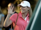 Skier Lindsey Vonn waves after watching Tiger Woods during the second round of the Masters on April 12, 2013