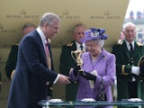 The Queen receives the Gold Cup after her horse Estimate won at Ascot on June 20, 2013