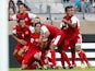 Tahiti's Jonathan Tehau is mobbed by team mates after scoring against Nigeria in the Confederations Cup on June 17, 2013