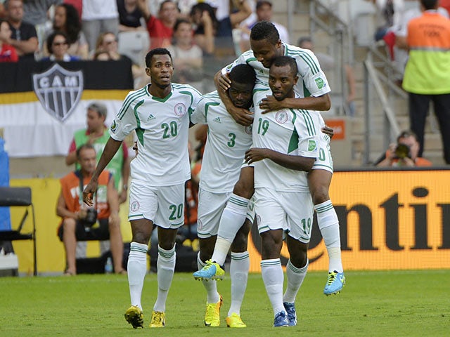 Nigeria's Uwa Echiejile is congratulated by team mates after scoring the opener against Tahiti in the Confederations Cup on June 17, 2013