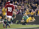 Australia's Adam Ashley-Cooper dives over to score a try against the British and Irish Lions during their rugby union test match on June 29, 2013