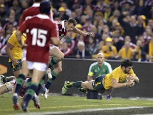 Australia's Adam Ashley-Cooper dives over to score a try against the British and Irish Lions during their rugby union test match on June 29, 2013
