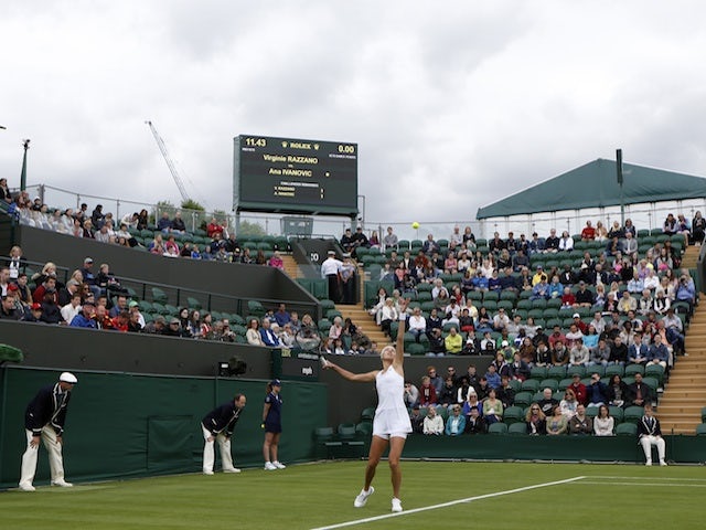 Ana Ivanovic serves against Virginie Razzano at Wimbledon on June 24, 2013