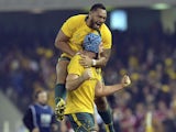 Australia's Sekope Kepu leaps onto James Horwill, front, as they celebrate beating the British and Irish Lions' during their rugby union test match on June 29, 2013