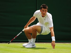 Australia's Bernard Tomic slips in his match against USA's Sam Querrey during the first round of Wimbledon on June 25, 2013