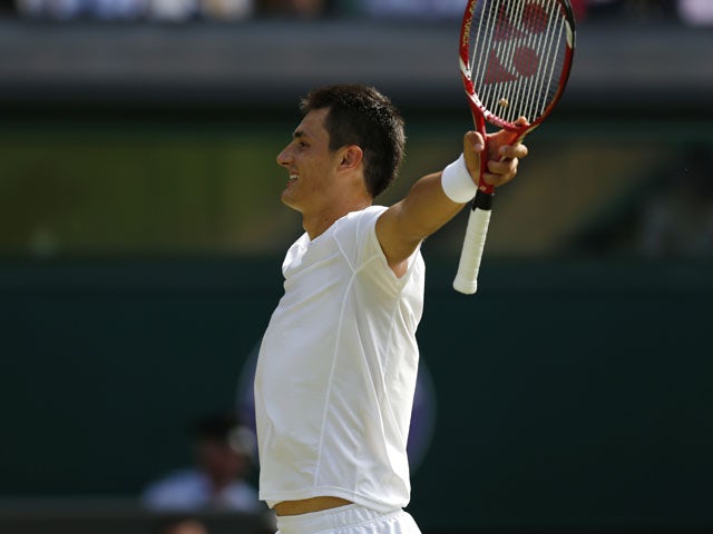 Tomic moves into round four
