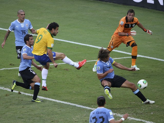 Brazil's Fred scores the opening goal during the soccer Confederations Cup semifinal match between Brazil and Uruguay on June 26, 2013