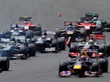 Debris flies across the circuit during the first lap of the British Grand Prix at Silverstone on June 30, 2013