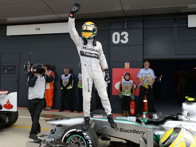Mercedes driver Lewis Hamilton celebrates after taking pole during qualifying for the British Grand Prix on June 29, 2013
