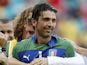 A teammate embraces Italy's Gianluigi Buffon after he saved the decisive shot during the penalty shoot-out at the soccer Confederations Cup third-place match against Uruguay on June 30, 2013