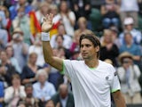 David Ferrer of Spain gestures to the public after defeating Martin Alund of Argentina in their Men's first round singles on June 25, 2013