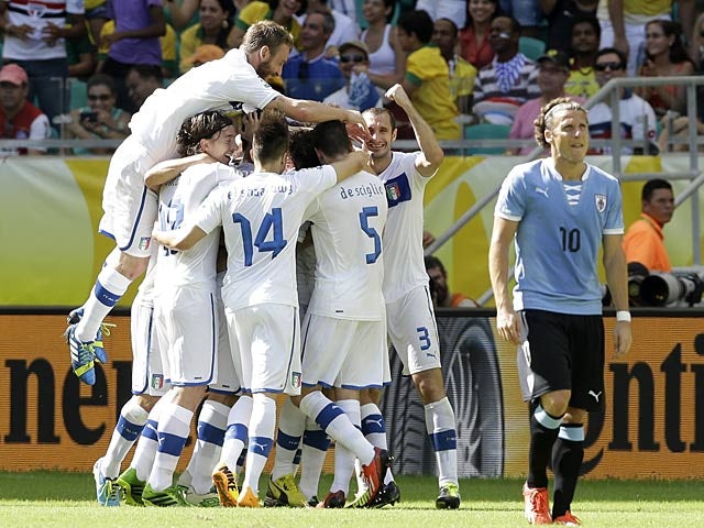 Italy's Davide Astori is mobbed by team mates after scoring the opening goal against Uruguay during their Confederations Cup match on June 30, 2013