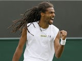 Dustin Brown of Germany reacts after winning a point against Lleyton Hewitt of Australia during their Men's second round singles match on June 26, 2013